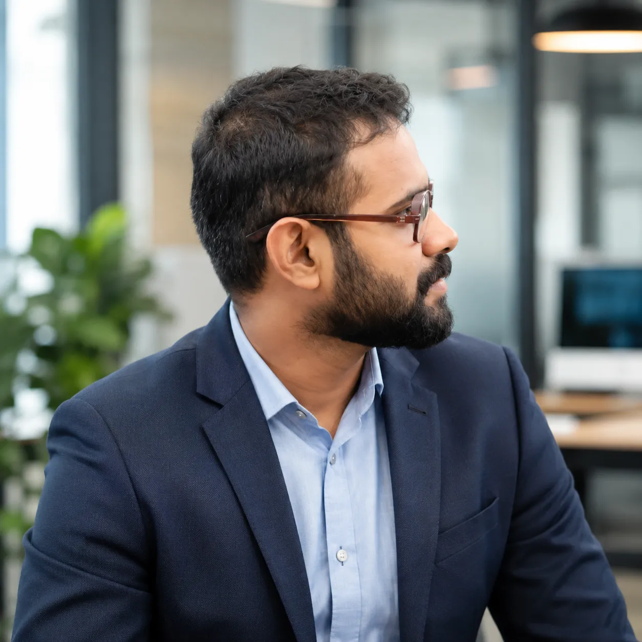 Akhil P Dev, Customer Consultant and Relationship Manager at OurHosting.in, professional portrait in a tech office